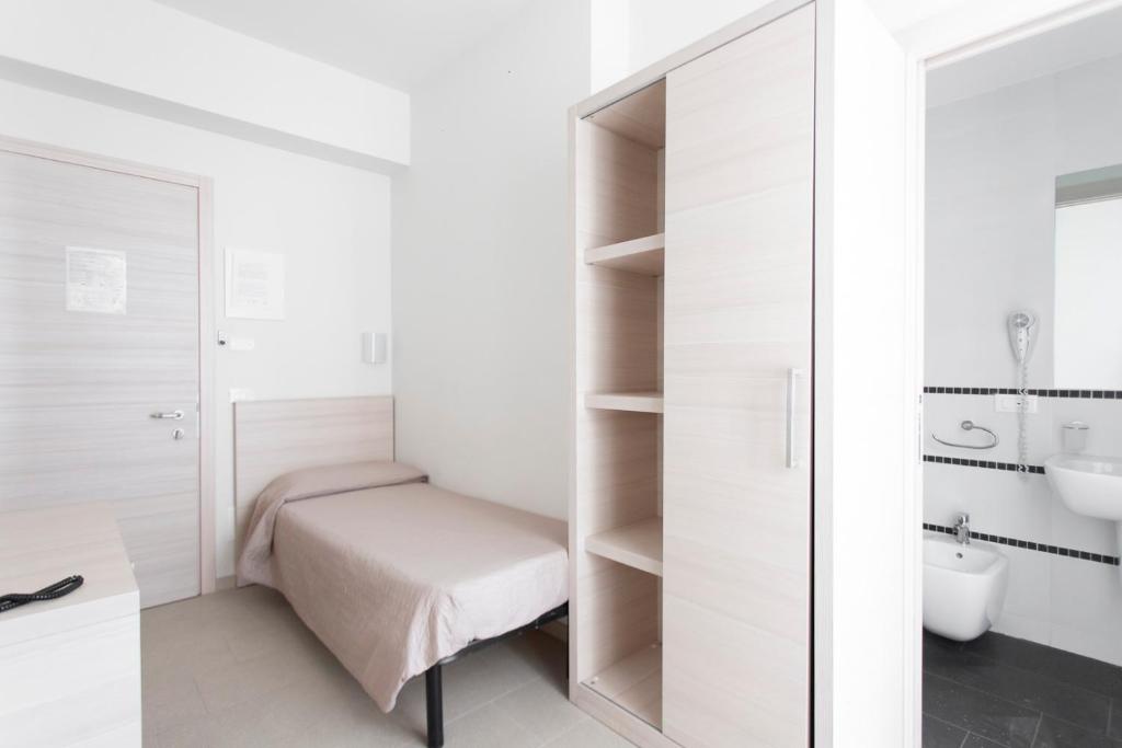 Postel nebo postele na pokoji v ubytování Hotel Primiana
