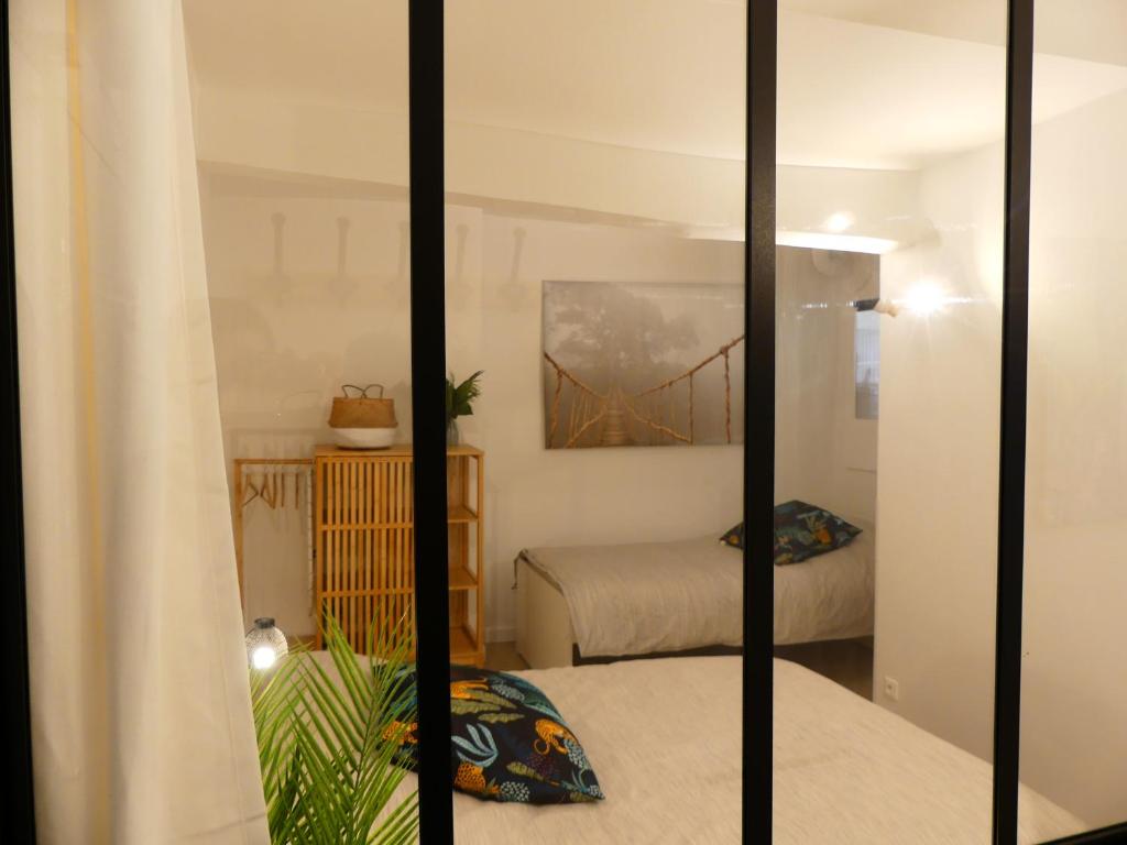 a view of a bedroom with a bridge reflected in a mirror at LE BEDARRIDE in Aix-en-Provence