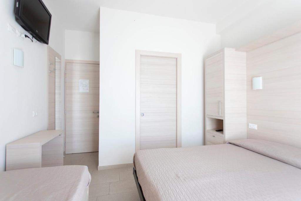 Postel nebo postele na pokoji v ubytování Hotel Primiana