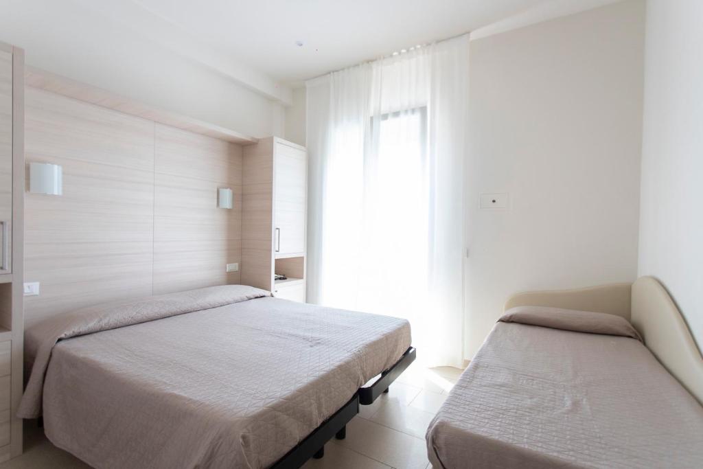 Postel nebo postele na pokoji v ubytování Hotel Primiana