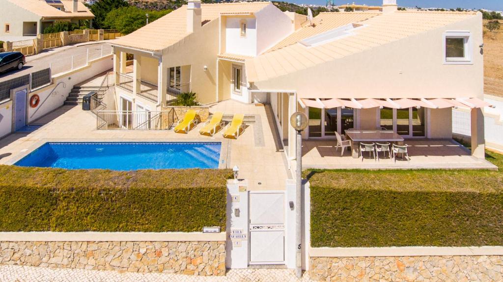 an aerial view of a house with a swimming pool at Villa Rafaella II Palace in Albufeira