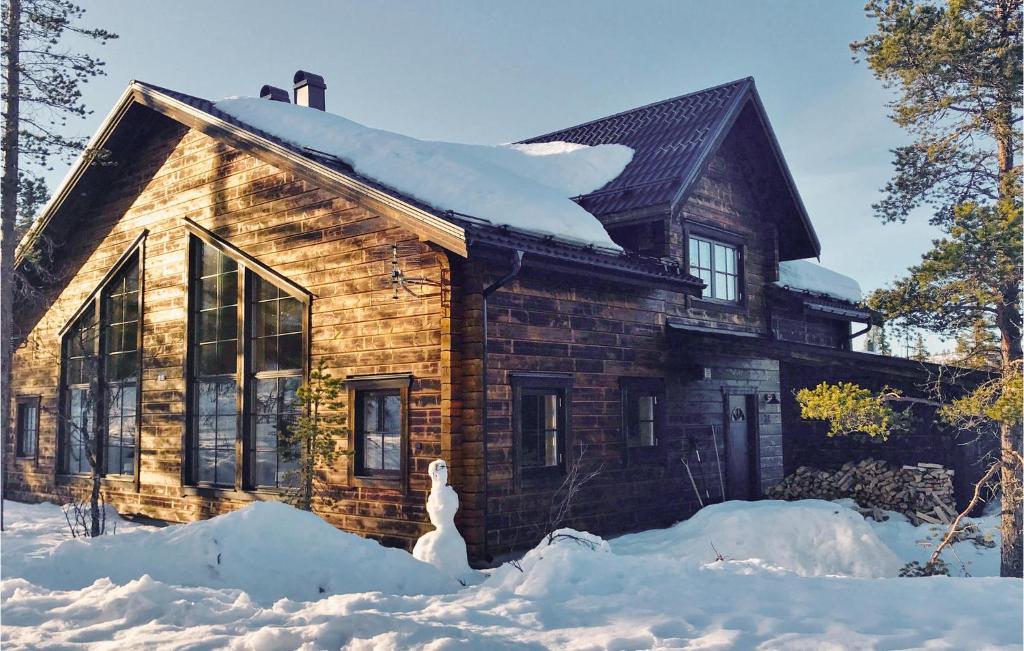 a log cabin with snow on the ground in front of it at Amazing Home In Vemdalen With Wifi in Vemdalen