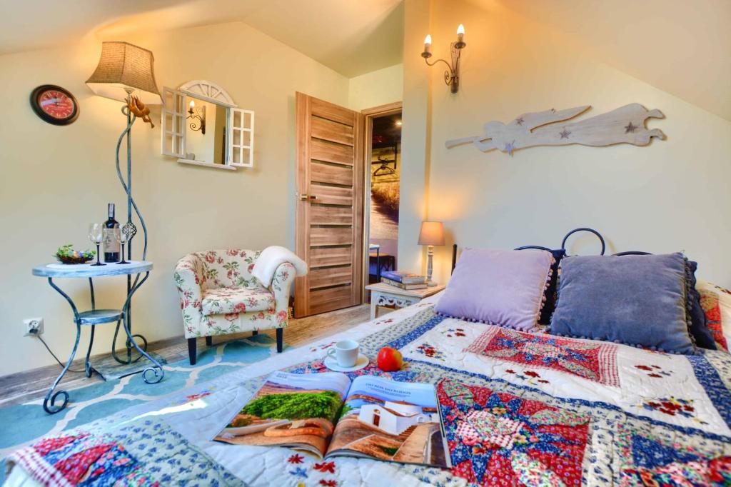 a bedroom with a bed and a table and a chair at Apartament Bieszczadzkie Klimaty in Ustrzyki Dolne