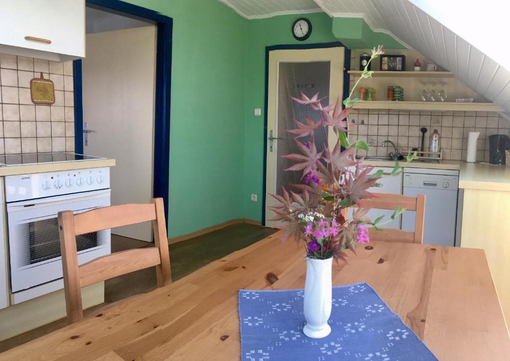 a vase of flowers on a table in a kitchen at P43 Apartment in Villach