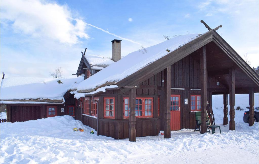 a log cabin with snow on the roof at Gorgeous Home In Rn With Wifi in Ron