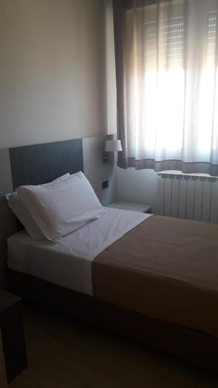 Postel nebo postele na pokoji v ubytování Hotel Cinzia