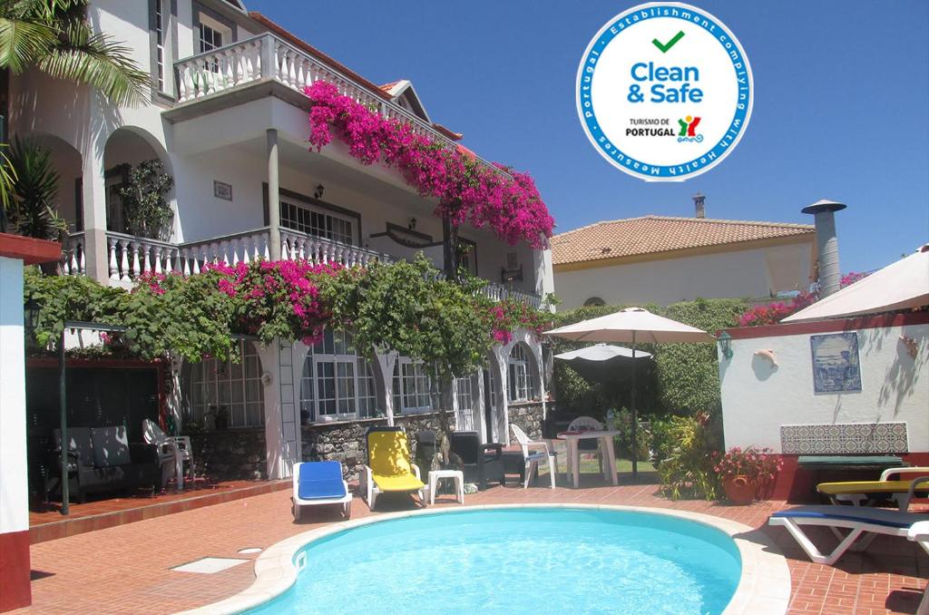 a hotel with a swimming pool in front of a building at Apartments Vista Oceano in Funchal