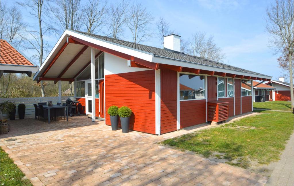 a red and white house with a patio at Lovely Home In Aabenraa With Kitchen in Aabenraa