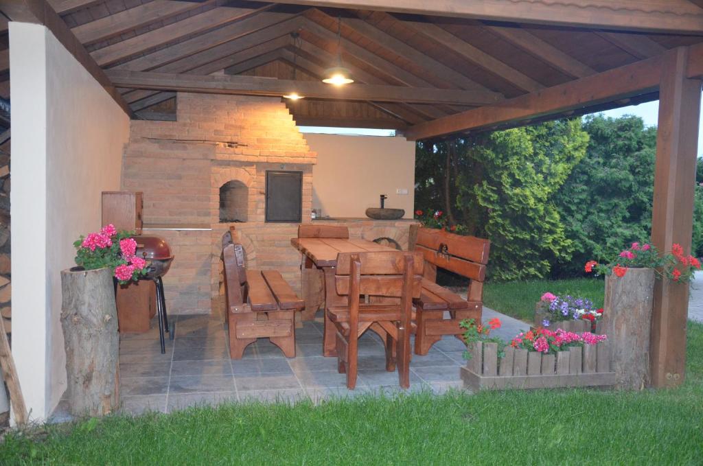 a patio with a table and chairs and a fireplace at penzion U Koníčka in Strážiště