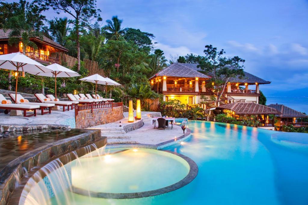 a swimming pool in front of a resort at Bunaken Oasis Dive Resort and Spa in Bunaken