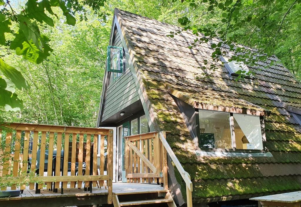 drewniany domek z dużym oknem i werandą w obiekcie Modern A-Frame vakantiehuis Durbuy Ardennen w mieście Durbuy