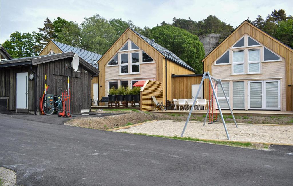 a house with a playground in front of it at Beautiful Home In Sgne With Wifi in Søgne