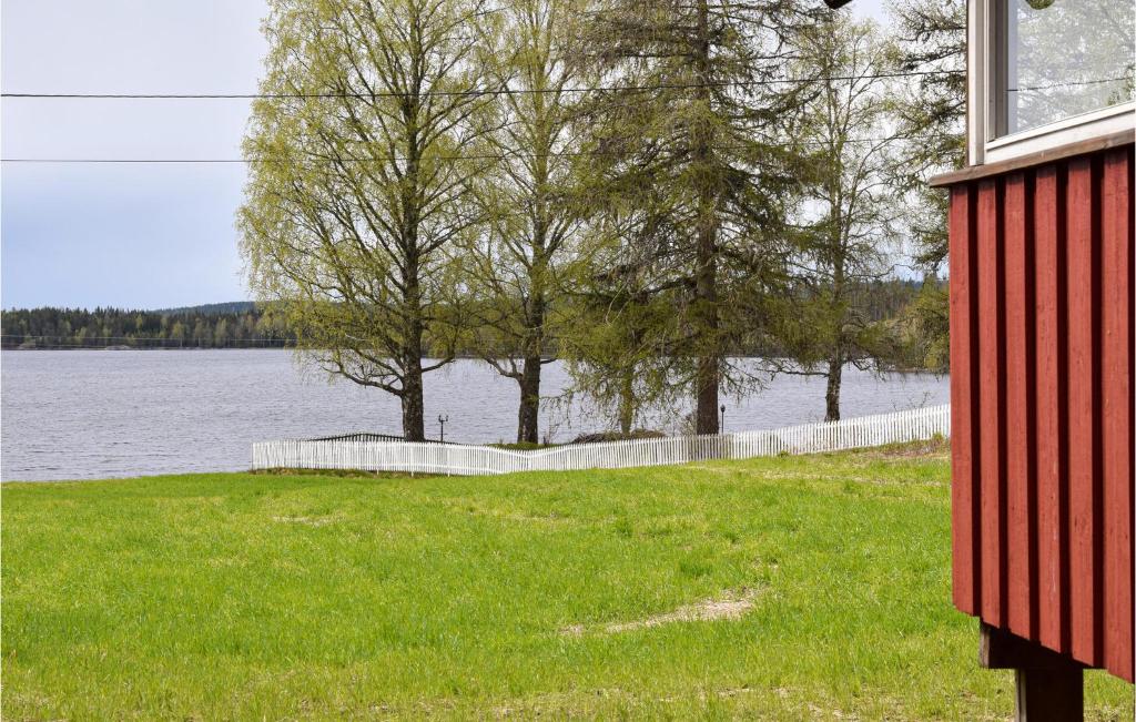 a red house next to a body of water at Awesome Home In Hemnes With Kitchen in Hemnes