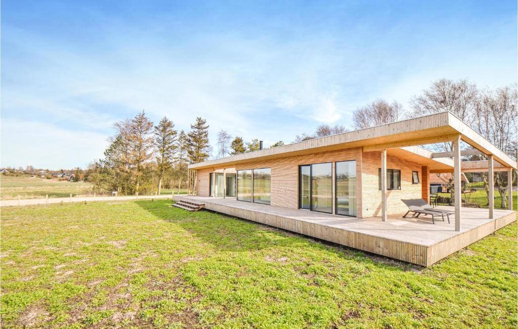 a brick house with a bench on a lawn at Lovely Home In Ebeltoft With Wifi in Ebeltoft