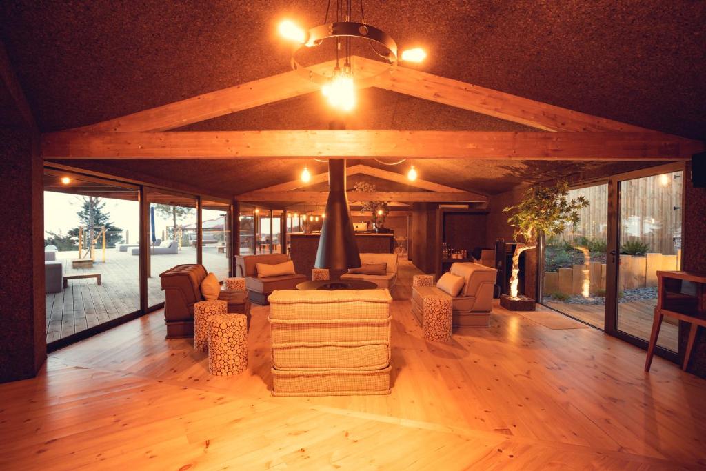 a large living room with couches and chairs and a ceiling at Charm Nature in Azoia
