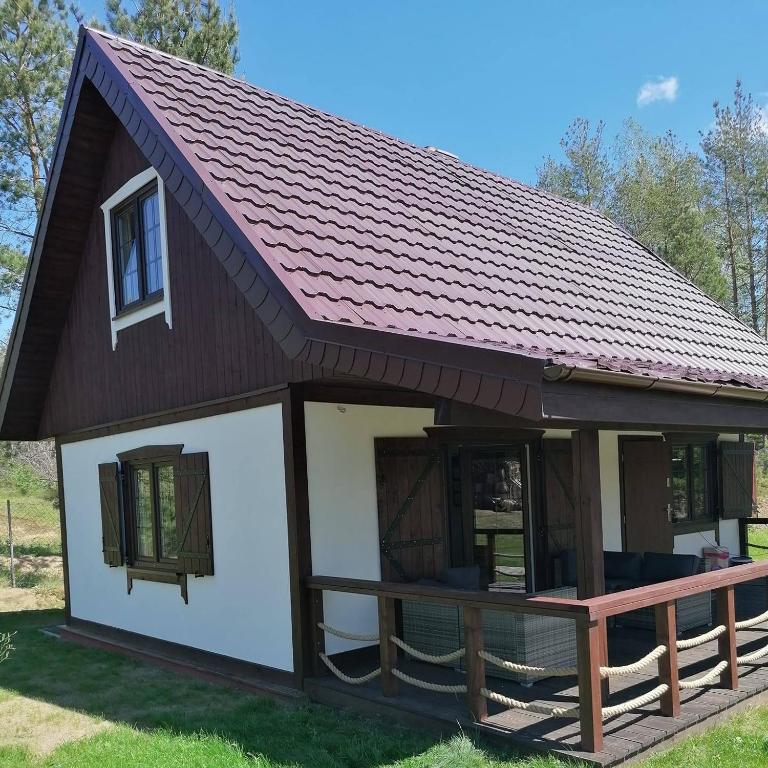 a small house with a pitched roof at Domek na Kaszubach nad Jeziorem in Kłodno