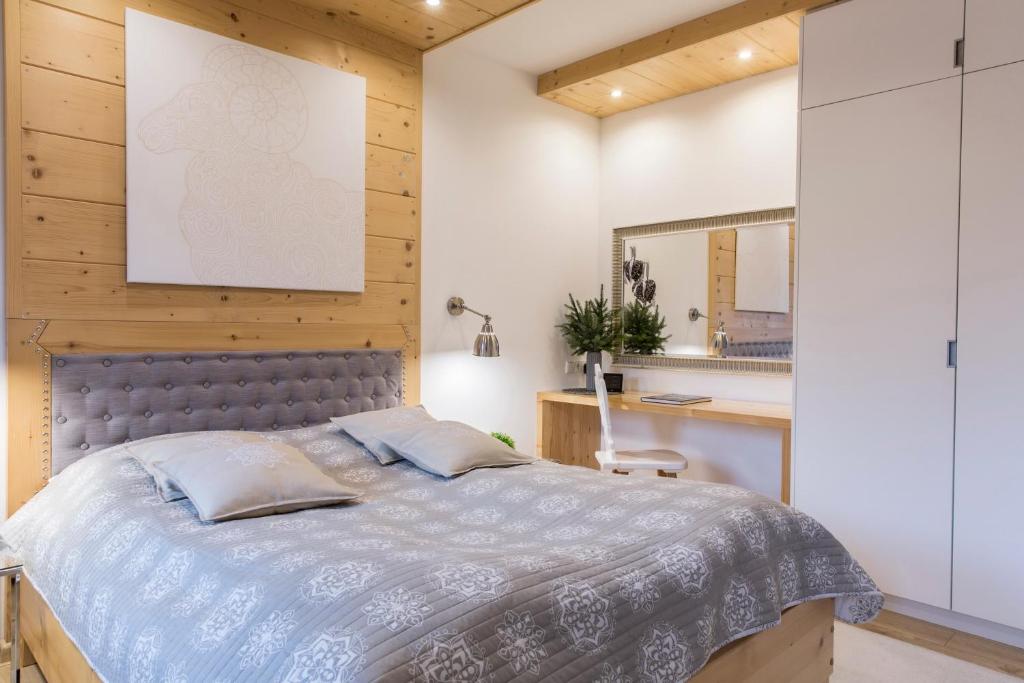 een slaapkamer met een bed en een spiegel bij Apartament Owczarnia Zakopane in Zakopane