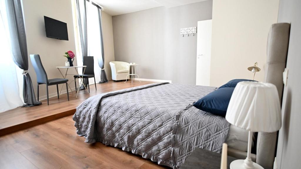 a bedroom with a bed and a table and chairs at L'Iris B&B in Terrazza in Lucca