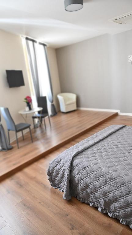 a bedroom with a bed on a wooden floor at L'Iris B&B in Terrazza in Lucca