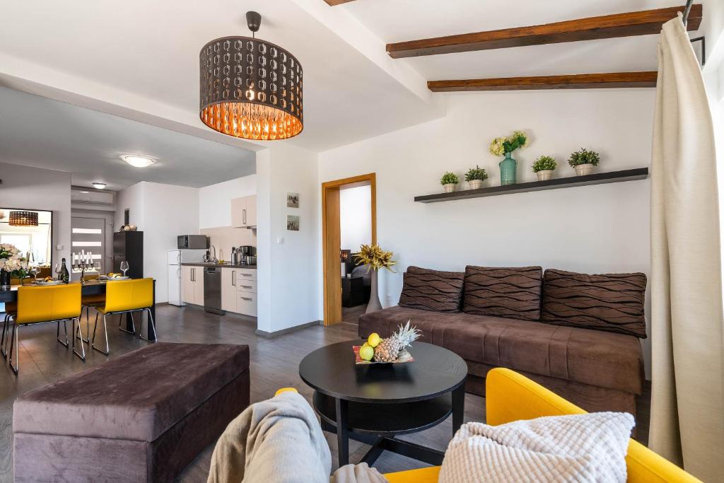 a living room with a couch and a table at Apartman Bijeca - Medulin in Medulin
