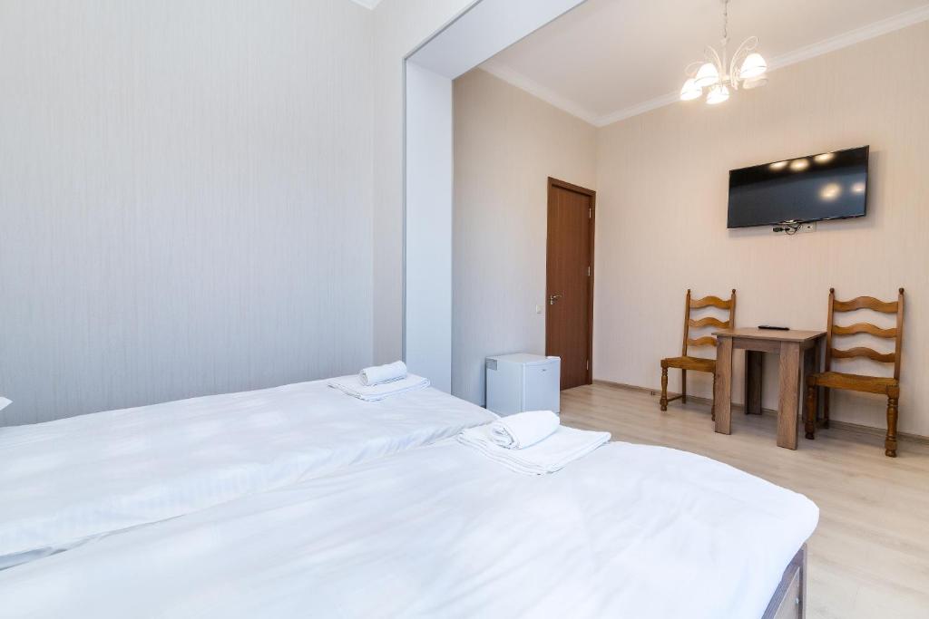 Postel nebo postele na pokoji v ubytování White Hotel Guesthouse