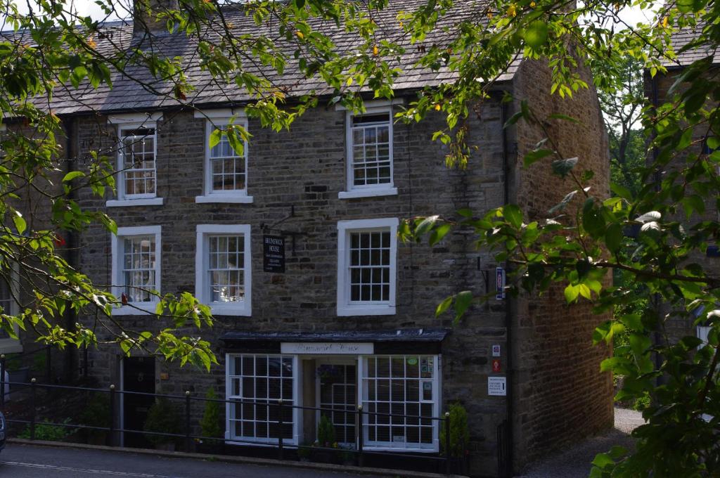 an old brick house with white windows at Brunswick House in Middleton in Teesdale