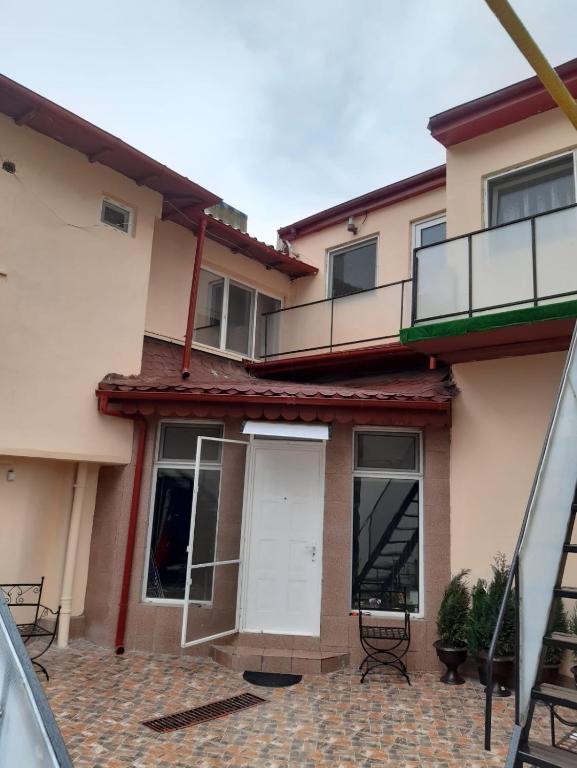 a house with a white door and a balcony at Villa Sun & Sea in Constanţa