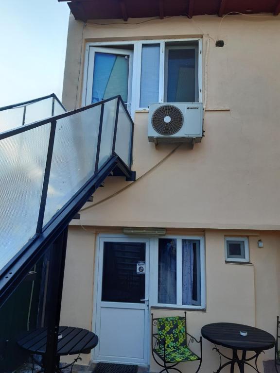 a balcony with a table and a fan on a building at Villa Sun & Sea in Constanţa