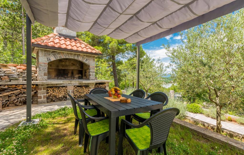 a table and chairs in front of a fireplace at Apartments Mioković in Soline