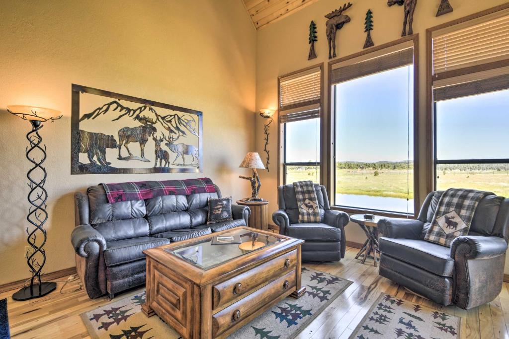 Pagosa Springs Townhome with View Hike and Fish! في باغوسا سبرينغز: غرفة معيشة مع أريكة وكراسي ونوافذ