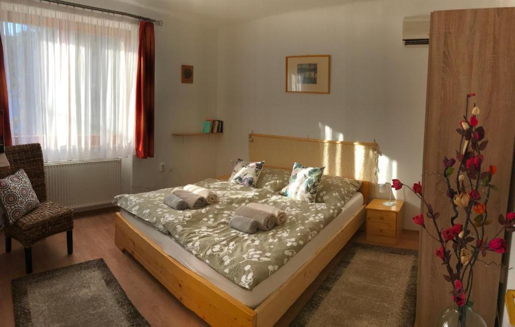a bedroom with a bed with pillows on it at Orsi House in Szombathely