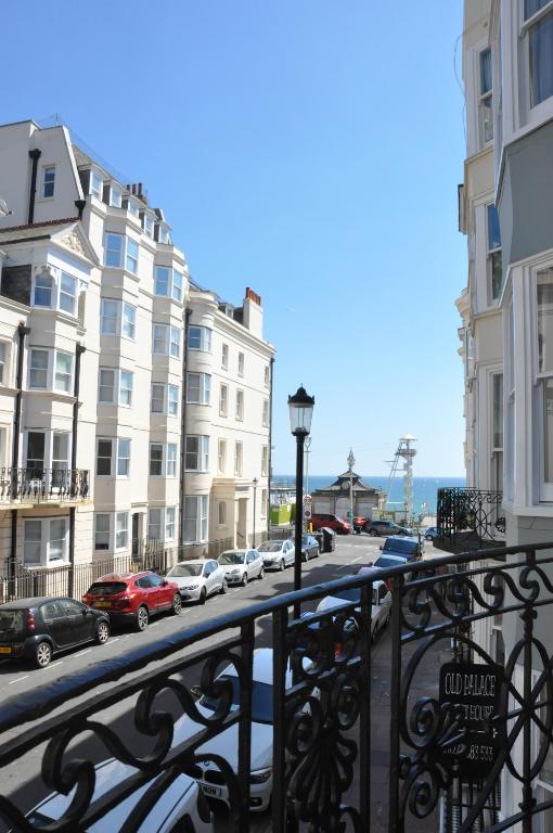 a balcony with cars parked on a street with buildings at Relax Inn Guest House in Brighton & Hove