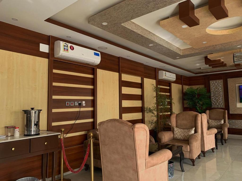 a waiting room with chairs and a air conditioner at Alshahamah Hotel Apartments in Najran