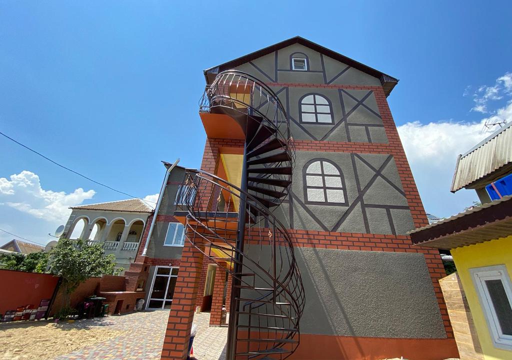 a building with a spiral staircase in front of it at Катюша морская in Zatoka
