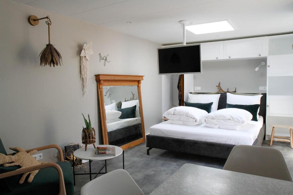 a hotel room with two beds and a mirror at Fabel aan Zee in Zandvoort