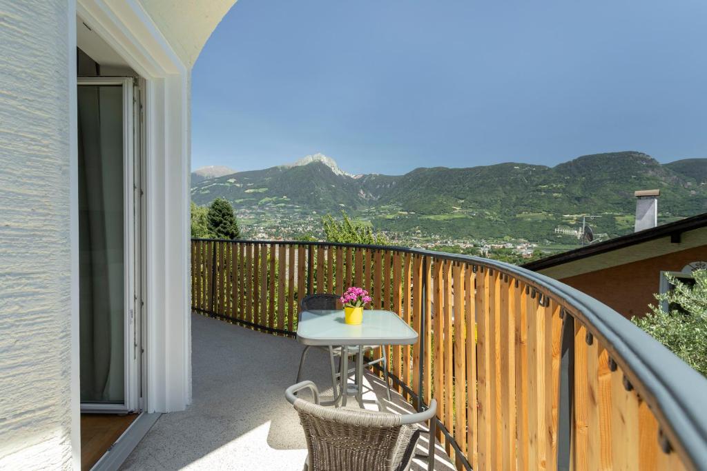 a table and chairs on a balcony with a view at MeranoView Apartments in Marlengo