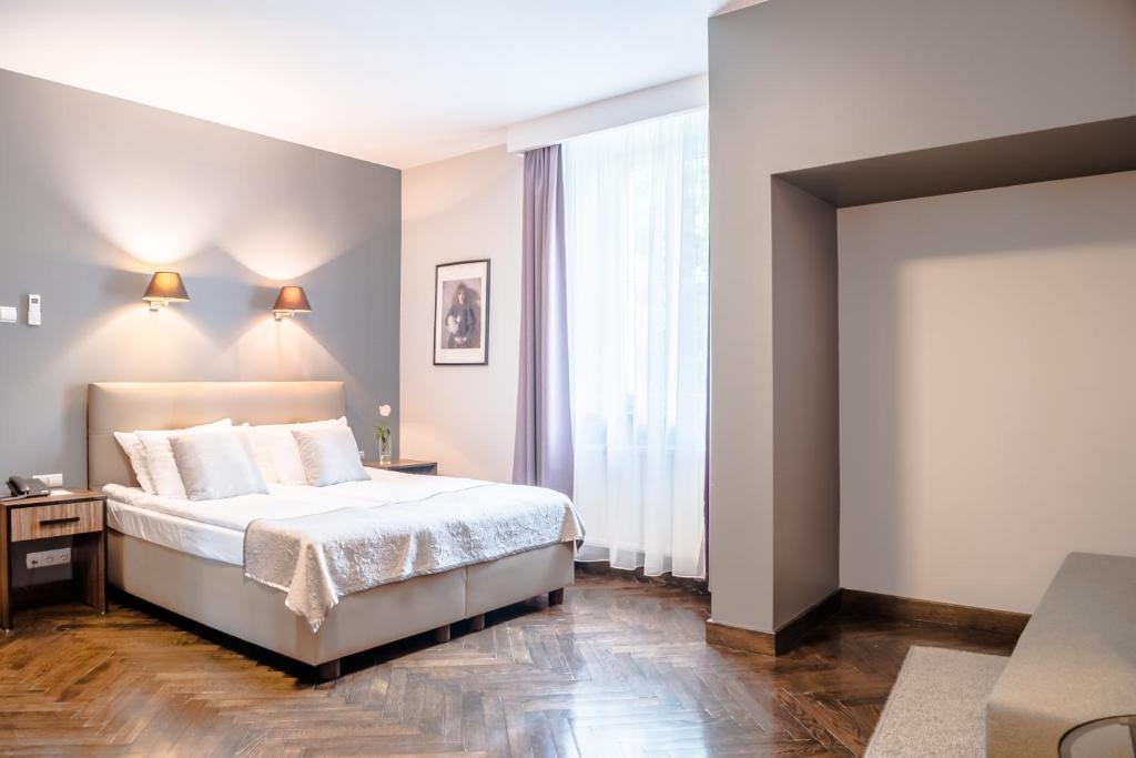 Posteľ alebo postele v izbe v ubytovaní Grottger Luxury Boutique Hotel City