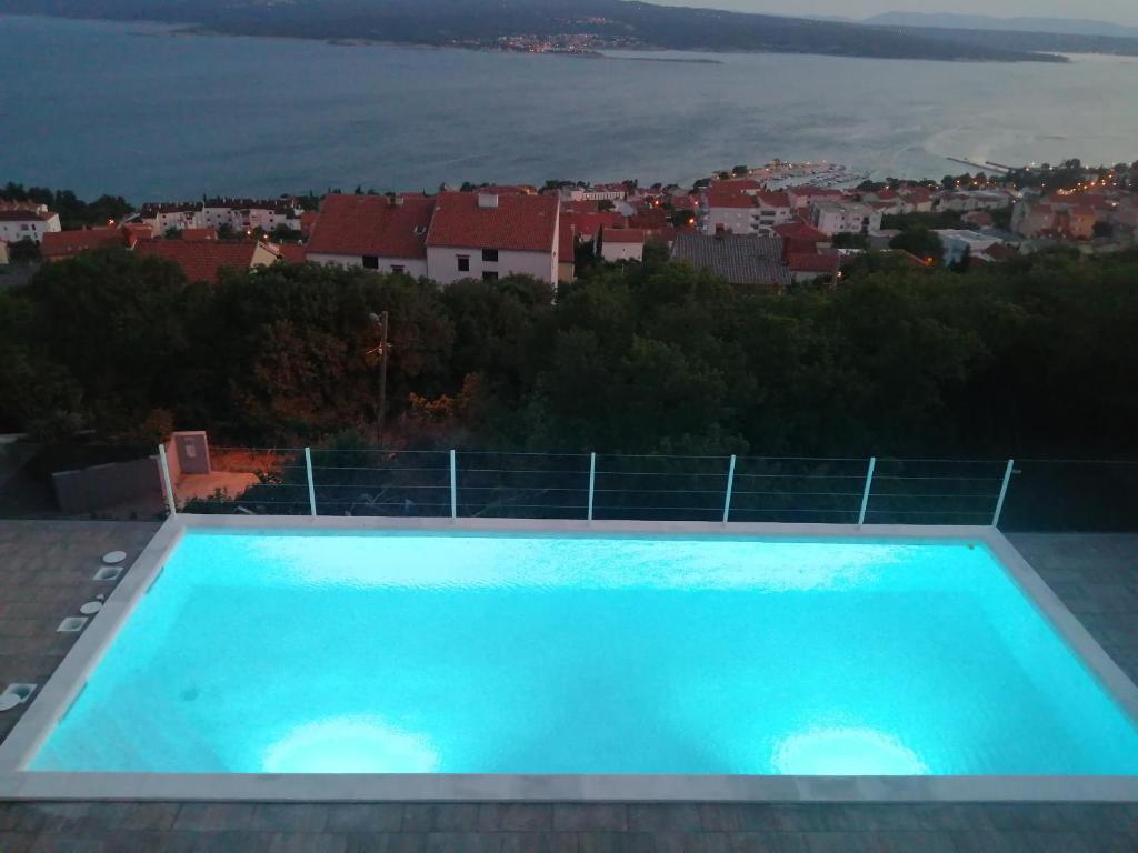 a large blue swimming pool on the roof of a house at Apartments Panorama in Crikvenica