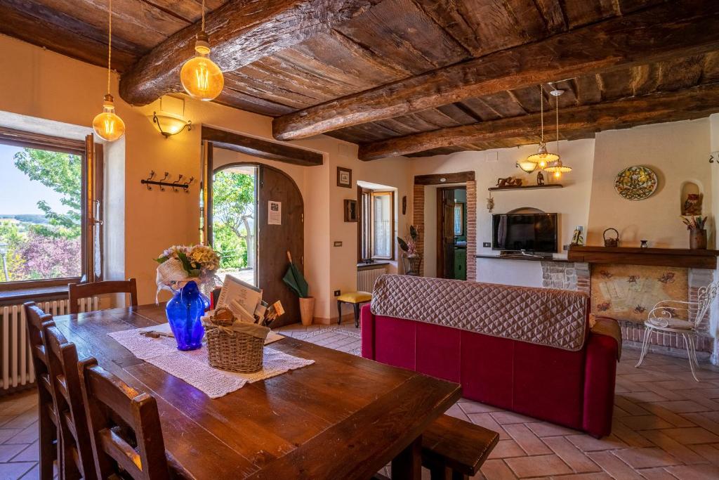 cocina y comedor con mesa de madera en Villa Rustica Le Piagge, en Sassoferrato