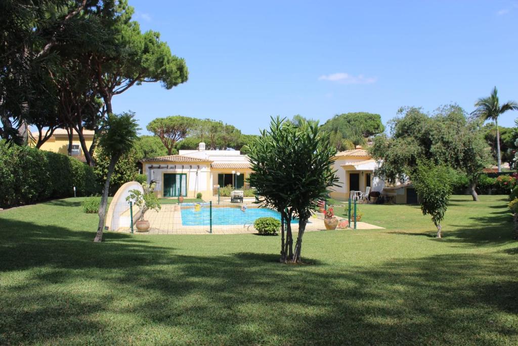 a house with a swimming pool in a yard at The Pinewood Villa in Vilamoura