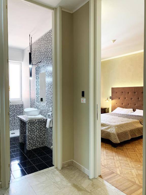 Postel nebo postele na pokoji v ubytování L'Attico di Piazza Mazzini Rooms