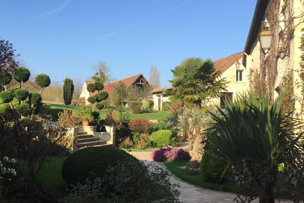 a house with a garden with trees and bushes at Beautiful country house located 50min from Paris Eiffel Tour - Demeure d'exception à 50min de Paris Tour Eiffel in Hodent