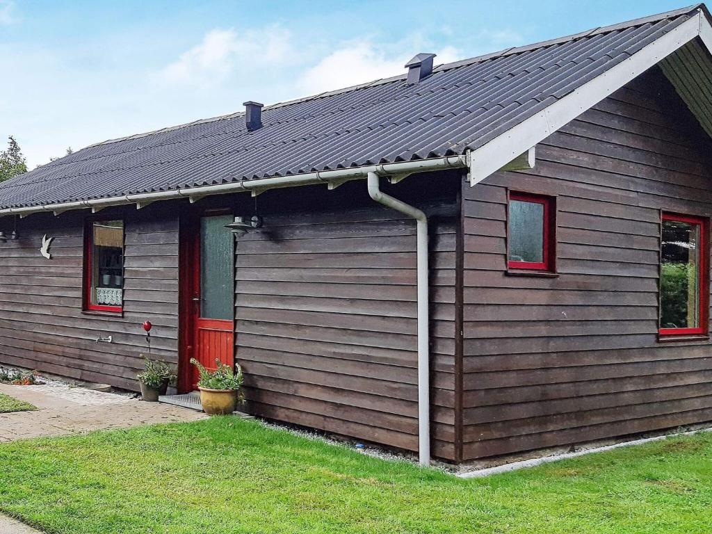 a brown house with a red door at 6 person holiday home in Hemmet in Hemmet