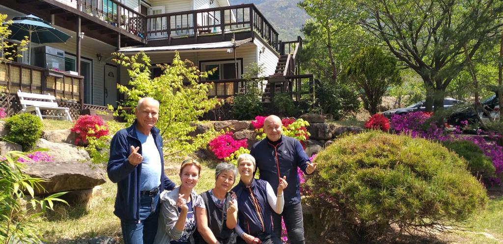 a group of people standing in front of a house at Chamjoeun Pension in Jecheon