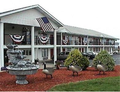 a building with a fountain in front of a building with flags at Twinkle Inn in Branson