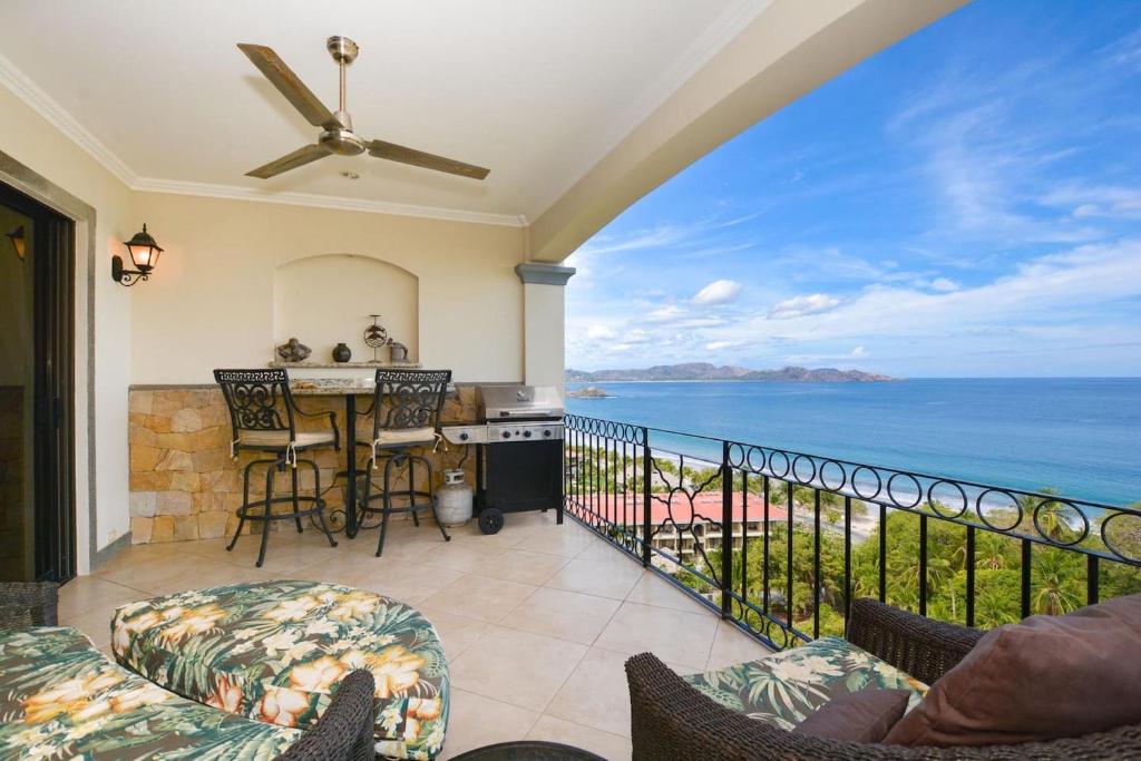 a balcony with a view of the ocean at Exquisitely decorated 5th-floor aerie with views of two bays in Flamingo in Playa Flamingo