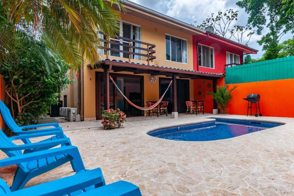 a house with a pool and chairs in front of it at Nicely Priced Duplex in Surfside with Private Pool and AC in Every Room in Potrero
