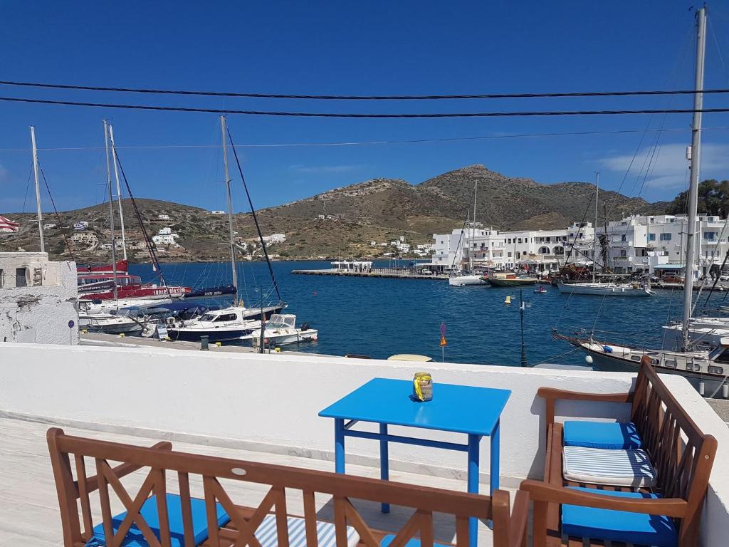 a table and chairs on a balcony with a marina at Yacht Front Apartment - No 1 in Ios Chora