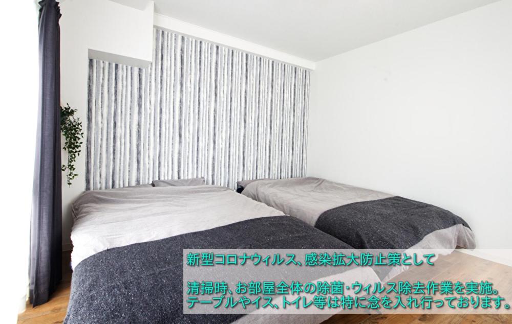 名古屋市にあるGuest House Re-worth Joshin1 4Fの白いベッドルーム(ベッド1台、窓付)
