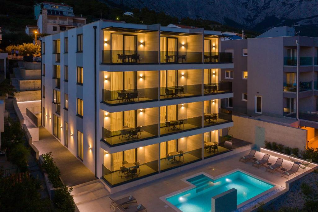 an aerial view of a building with a swimming pool at Fontevita Apartments in Baška Voda